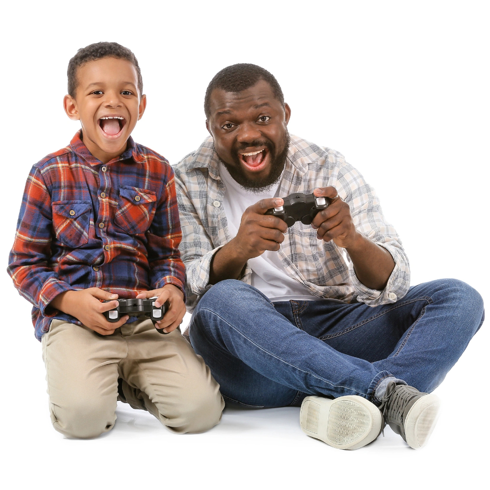 An adult and a child sit on the floor, smiling and holding video game controllers, appearing engaged in playing a game together—just like members of a gaming community moderator team enjoying some friendly competition. An adult and a child sit on the floor, smiling and holding video game controllers, appearing engaged in playing a game together—just like members of a gaming community moderator team enjoying some friendly competition.